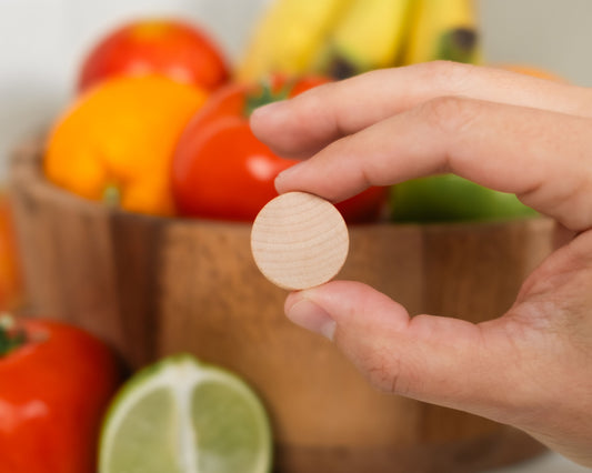 Fruit Fly Defense deterrent disc placed near a fruit bowl — a natural alternative to fruit fly traps