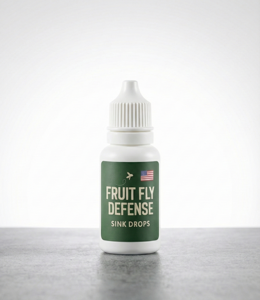 Bottle of 'Fruit Fly Defense Sink Drops' on a white background. Industry leading fruit fly deterrent meant for homes, kitchens, commercial applications.