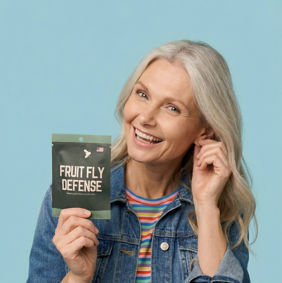 Woman holding a 'Fruity Fly Defense' package against a blue background